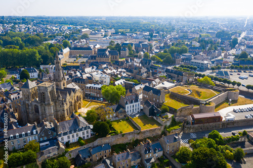 Flight over the city Guingamp and Basilica of Our Lady of Merciful on summer day. France