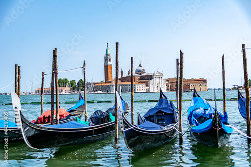 Gondolas mored in front of St. Mark's Square with San Giorgio di Maggiore church in the background Venice, Italy © Lukas