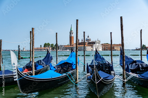 Gondolas mored in front of St. Mark's Square with San Giorgio di Maggiore church in the background Venice, Italy © Lukas