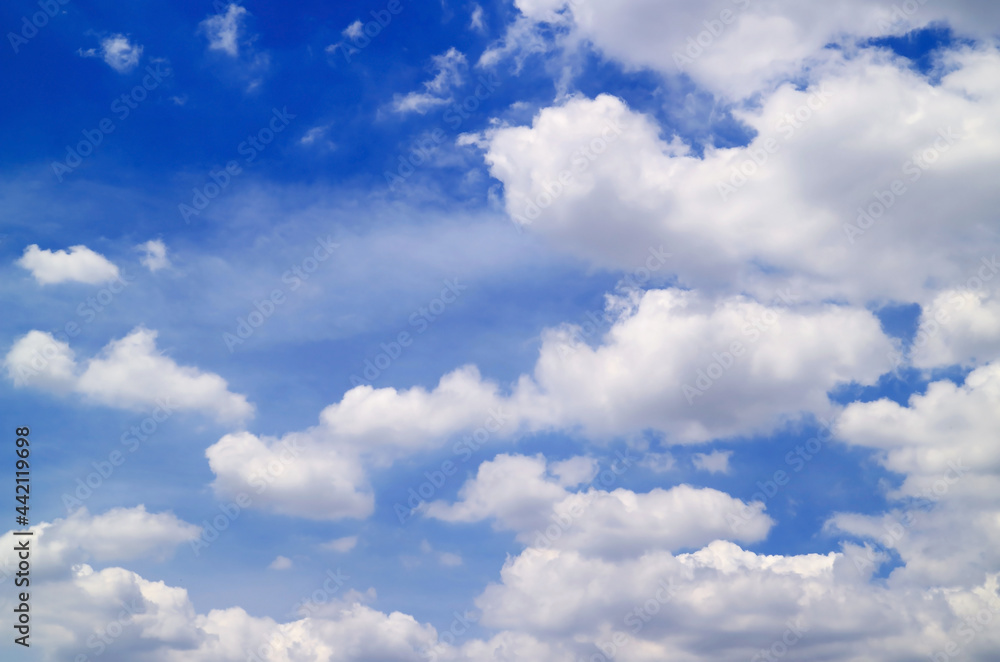 Fluffy white cumulus clouds floating on the blue sky Fluffy white cumulus clouds floating on the blue sky