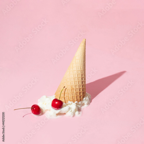 Obraz na płótnie Creative layout with ice cream cone up side down and vanilla ice cream scoop with two bright red cherries on pastel pink background