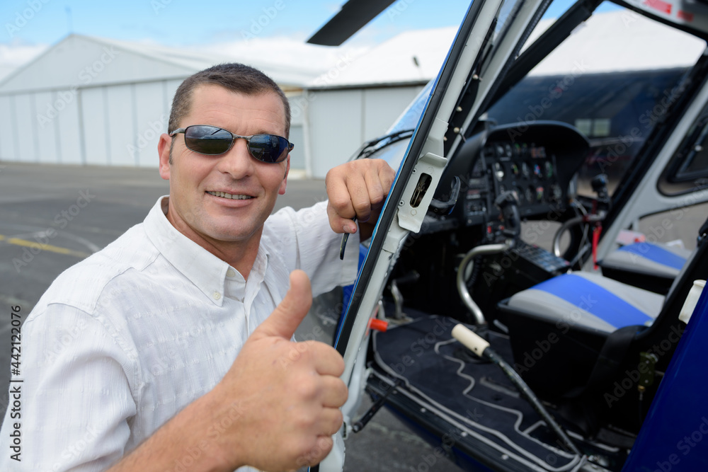 man helicopter pilot showing thumb-up