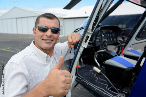 man helicopter pilot showing thumb-up © auremar