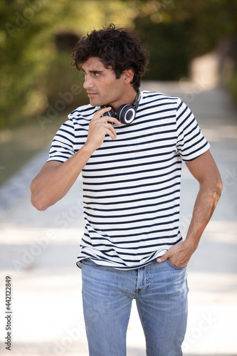 happy hipster man walking in the park