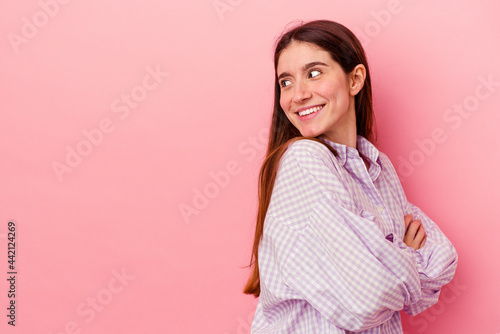 smiling confident with crossed arms.