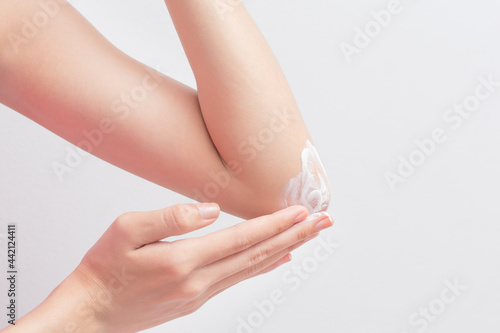 woman applying cream on their legs