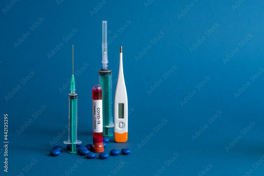 Medicine tablet, Thermometer and syringe or injection with a Test tube containing a blood sample for testing to the presence of coronavirus / COVID-19 Medicine tablet, Thermometer and syringe or injection with a Test tube containing a blood sample for testing to the presence of coronavirus / COVID-19