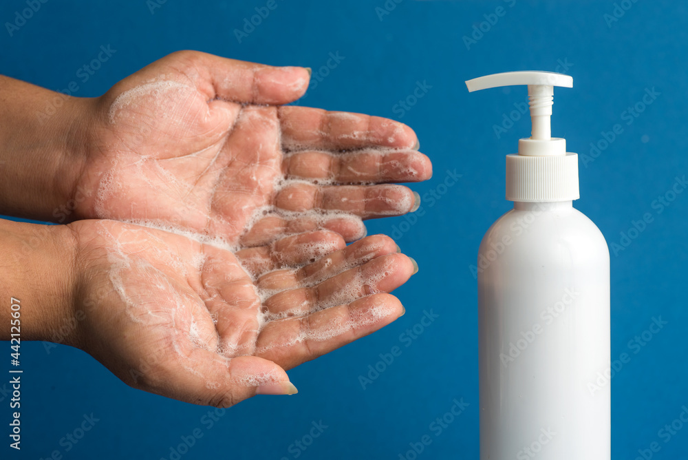Closeup of person washing hands or using a sanitizing gel. Cleanliness and body care concept. Closeup of person washing hands or using a sanitizing gel. Cleanliness and body care concept.