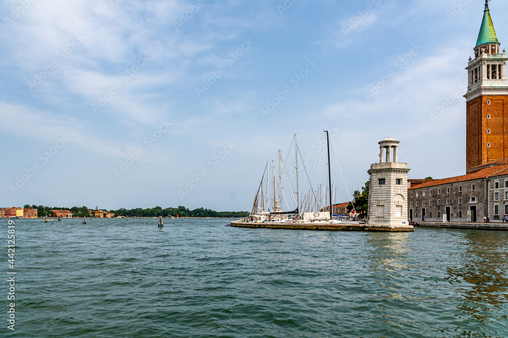 The Island of Saint George with an old lighthouse and the Belltower of the historic church in Venice, Italy