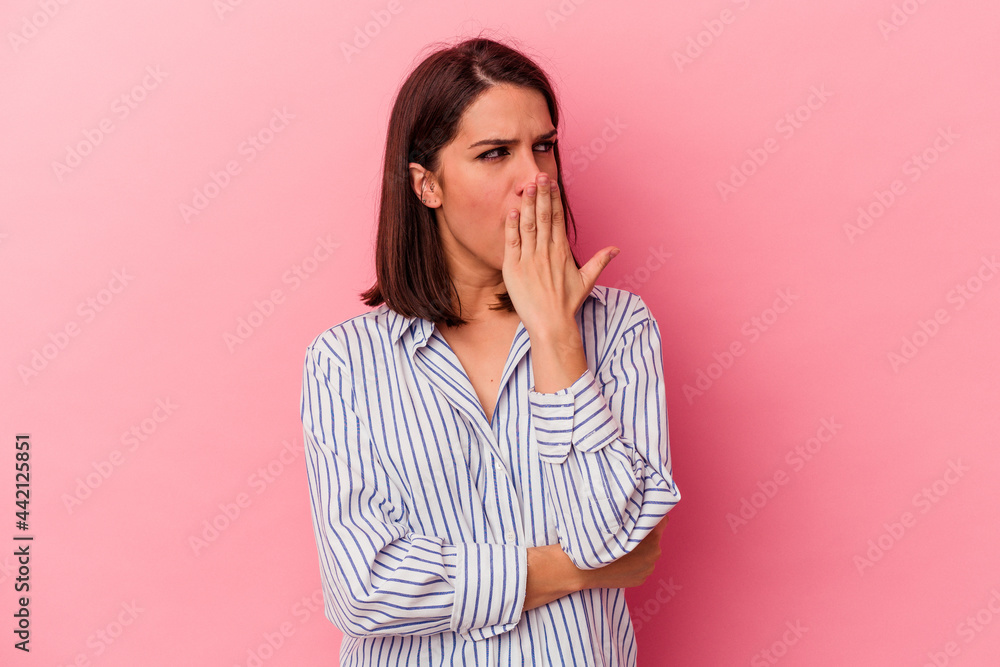 Young caucasian woman isolated on pink background yawning showing a tired gesture covering mouth with hand. Young caucasian woman isolated on pink background yawning showing a tired gesture covering mouth with hand.