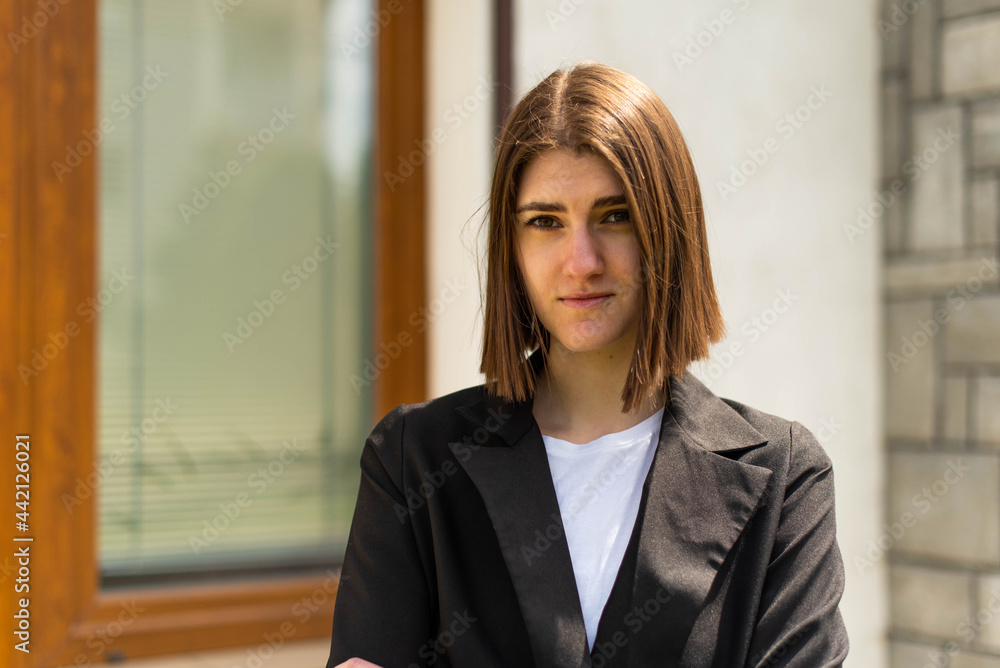 Business woman portrait outdoors. A young girl in business clothes poses for a photo session for resume. Business woman portrait outdoors. A young girl in business clothes poses for a photo session for resume.
