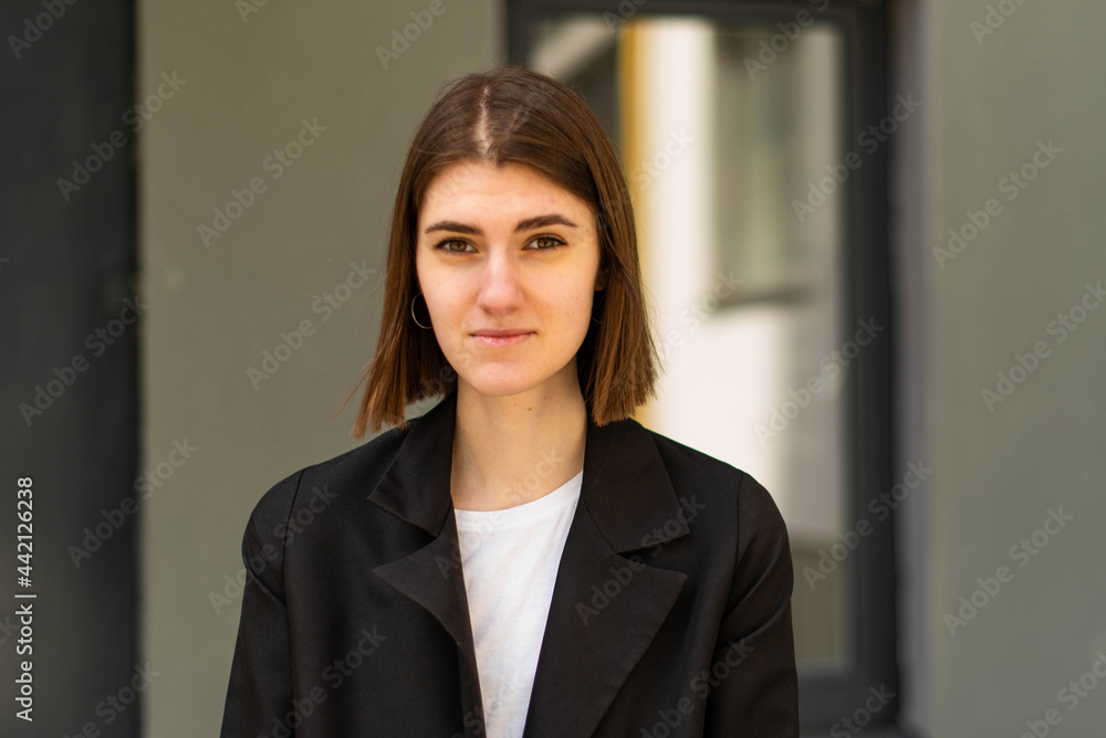 Business woman portrait outdoors. A young girl in business clothes poses for a photo session for resume. Business woman portrait outdoors. A young girl in business clothes poses for a photo session for resume.