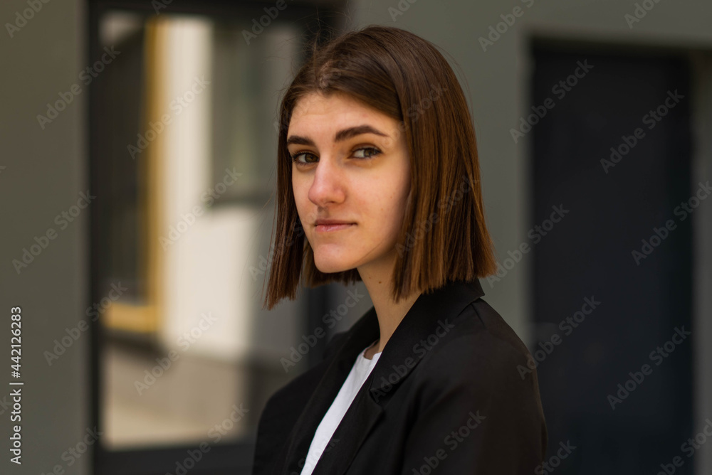 Business woman portrait outdoors. A young girl in business clothes poses for a photo session for resume. Business woman portrait outdoors. A young girl in business clothes poses for a photo session for resume.