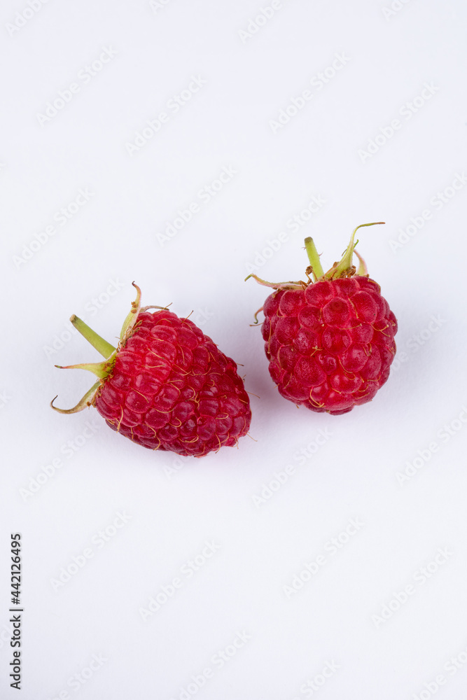 Isolated berries. Bunch of raspberry fruits with leaves isolated on white background, with clipping path Isolated berries. Bunch of raspberry fruits with leaves isolated on white background, with clipping path