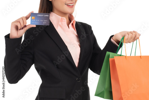 Beautiful businesswoman with credit card and shopping bags isolated on white background