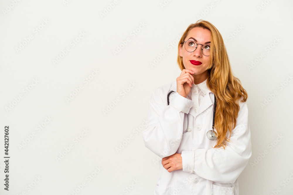 Caucasian doctor woman isolated on white background looking sideways with doubtful and skeptical expression. Caucasian doctor woman isolated on white background looking sideways with doubtful and skeptical expression.