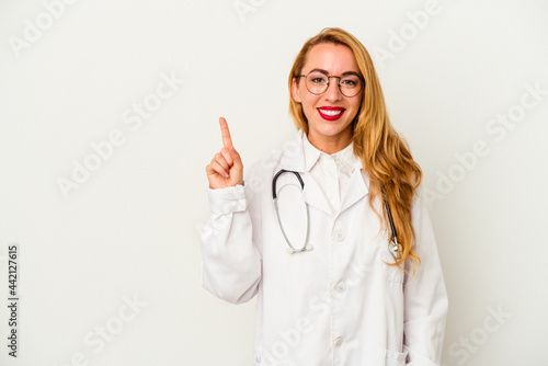 Caucasian doctor woman isolated on white background showing number one with finger.