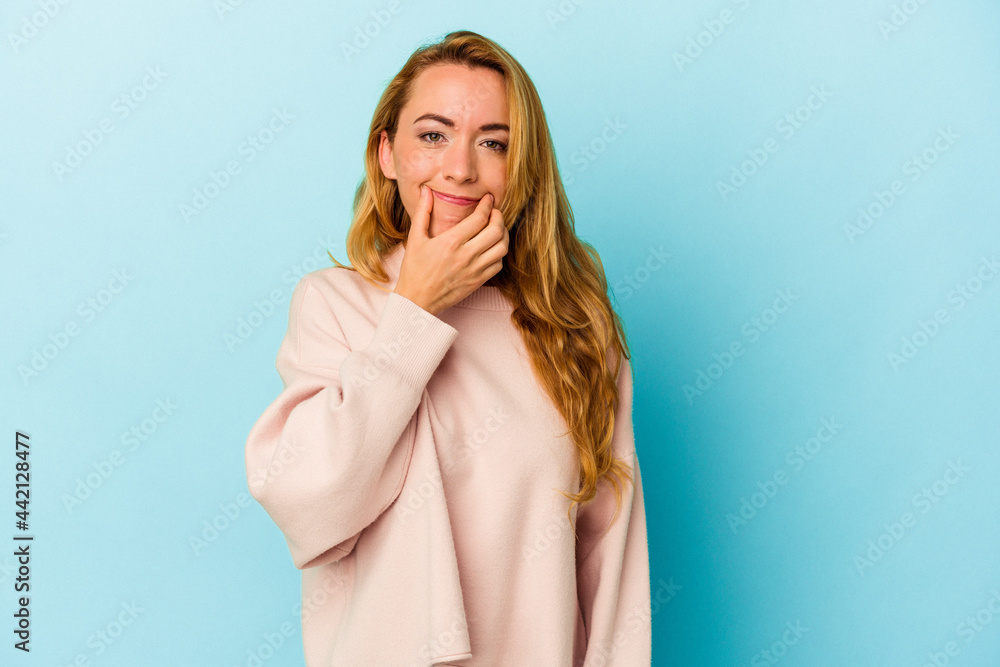 Caucasian woman isolated on blue background doubting between two options. Caucasian woman isolated on blue background doubting between two options.