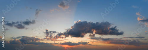 Cancer blue stormy sky with sun rays.