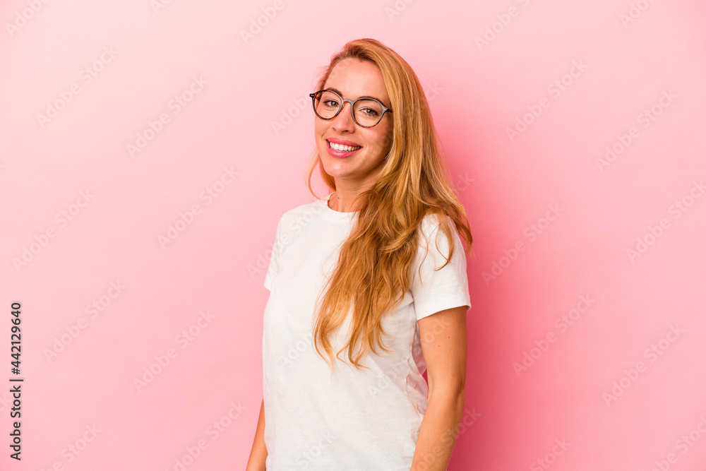 Caucasian blonde woman isolated on pink background confident keeping hands on hips. Caucasian blonde woman isolated on pink background confident keeping hands on hips.