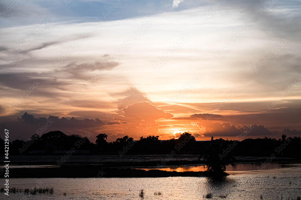 Evening sky sunset.  big puffy cumulus and long stratus clouds. sky background with clouds