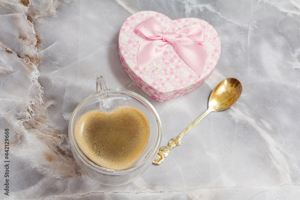 Cup of coffee and gift box on kitchen desk. Cup of coffee and gift box on kitchen desk.