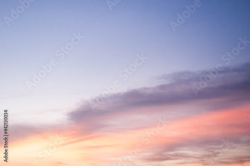 Evening sky sunset.  big puffy cumulus and long stratus clouds. sky background with clouds © Parichart