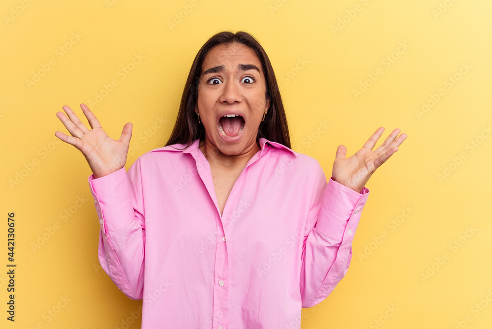 Young mixed race woman isolated on yellow background screaming to the sky, looking up, frustrated. Young mixed race woman isolated on yellow background screaming to the sky, looking up, frustrated.