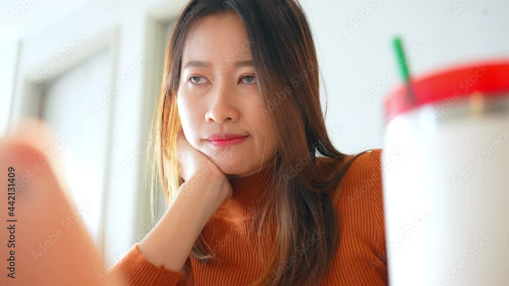 Asian woman use tablet with internet for online small business work on table in apartment. Female freelance type and scratch on tablet touch screen for working business job or online shopping at home. Asian woman use tablet with internet for online small business work on table in apartment. Female freelance type and scratch on tablet touch screen for working business job or online shopping at home.