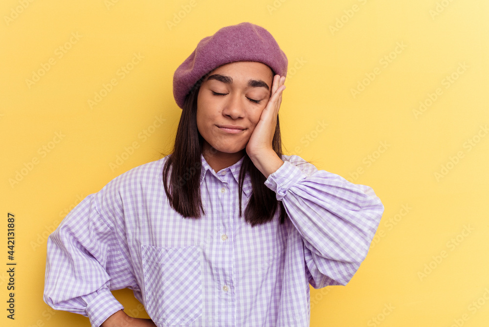 Young mixed race woman isolated on yellow background who is bored, fatigued and need a relax day. Young mixed race woman isolated on yellow background who is bored, fatigued and need a relax day.