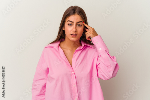 Young caucasian woman isolated on white background showing a disappointment gesture with forefinger. © Asier