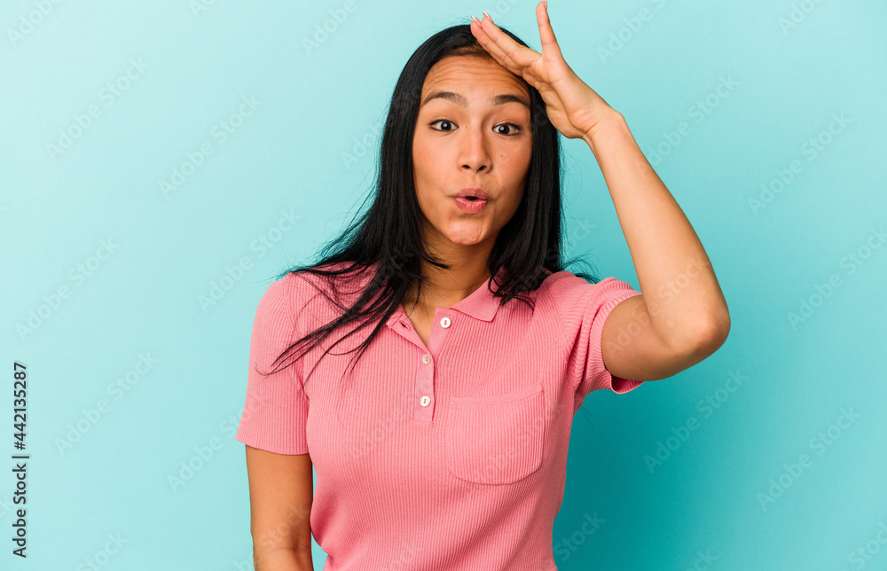 Young Venezuelan woman isolated on blue background looking far away keeping hand on forehead. Young Venezuelan woman isolated on blue background looking far away keeping hand on forehead.