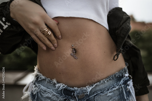 Canvas Print Closeup shot of a female belly with a navel piercing