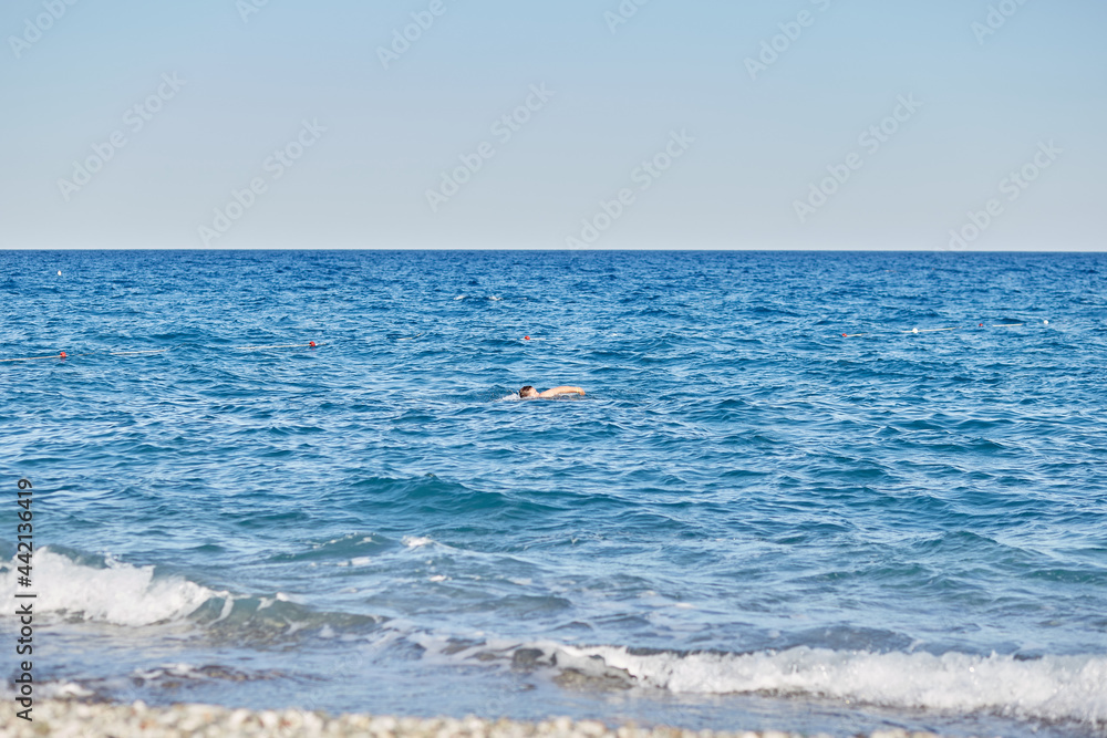 man swims in the sea. Summer vacation concept, tourism