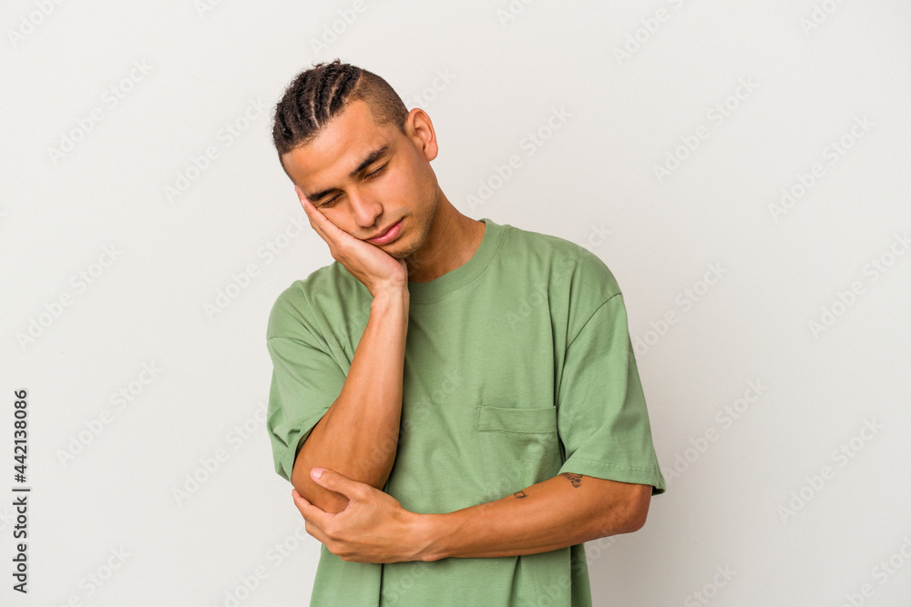 Young venezuelan man isolated on white background who is bored, fatigued and need a relax day. Young venezuelan man isolated on white background who is bored, fatigued and need a relax day.