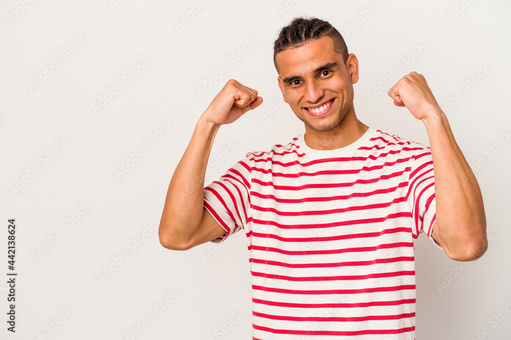 Young venezuelan man isolated on white background raising fist after a victory, winner concept. Young venezuelan man isolated on white background raising fist after a victory, winner concept.