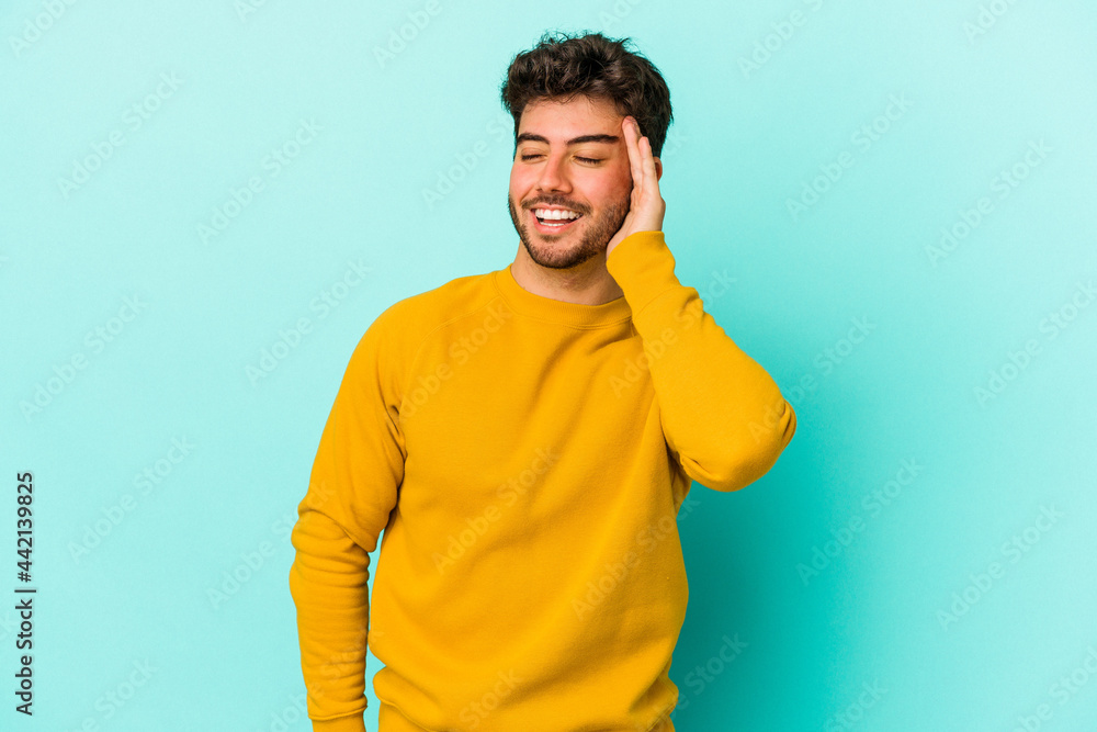 Young caucasian man isolated on blue background joyful laughing a lot. Happiness concept. Young caucasian man isolated on blue background joyful laughing a lot. Happiness concept.