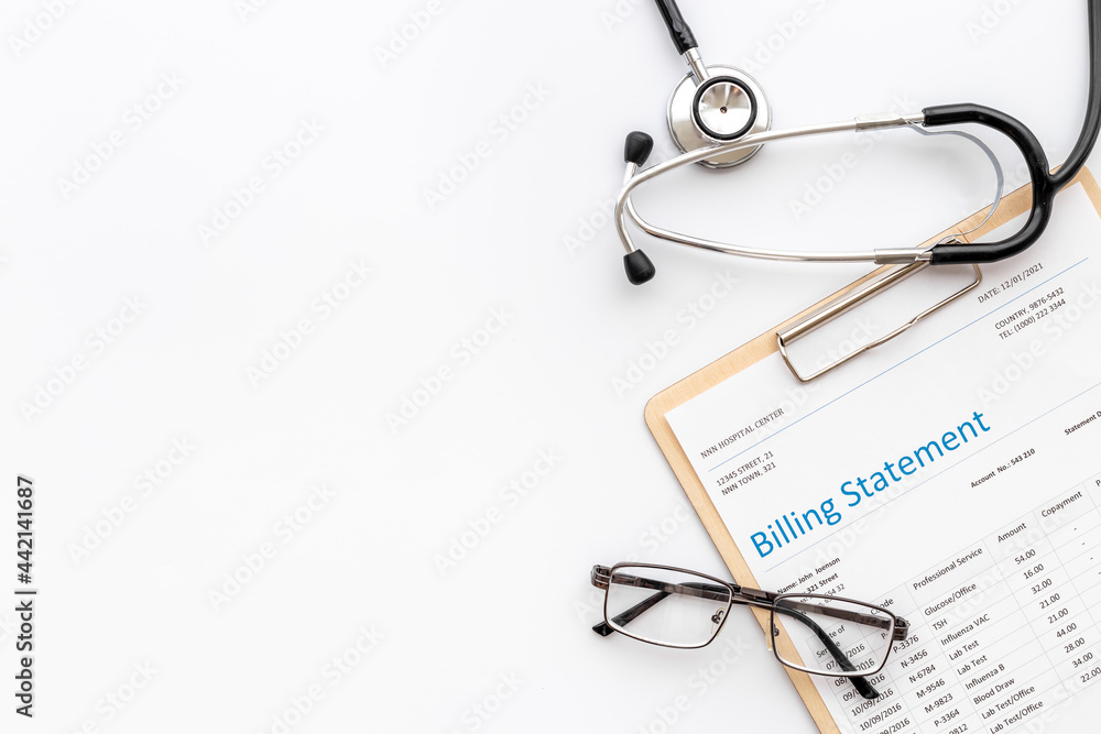 Medical billing statement with stethoscope. Top view Medical billing statement with stethoscope. Top view