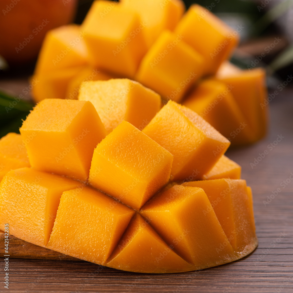 Mango. Fresh mango fruit with leaves over dark wooden table background. Mango. Fresh mango fruit with leaves over dark wooden table background.