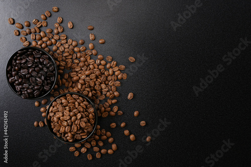 Fresh raw organic coffee beans on black.