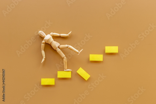 Man mannequin figure falling down from stairs. Accident failure and fiasco in business concept
