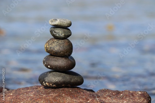Tower of pebble stones on a sea beach. Zen balance, tranquility concept