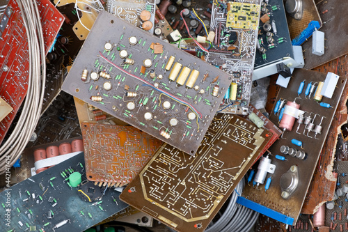 Heap of Used vintage old electronic hardware parts boards. Consumer electronics components capacitors from various electronics. Recycling Electronic waste concept photo