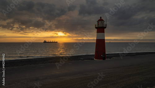 Lighthouse westkapelle with ship in the sunset