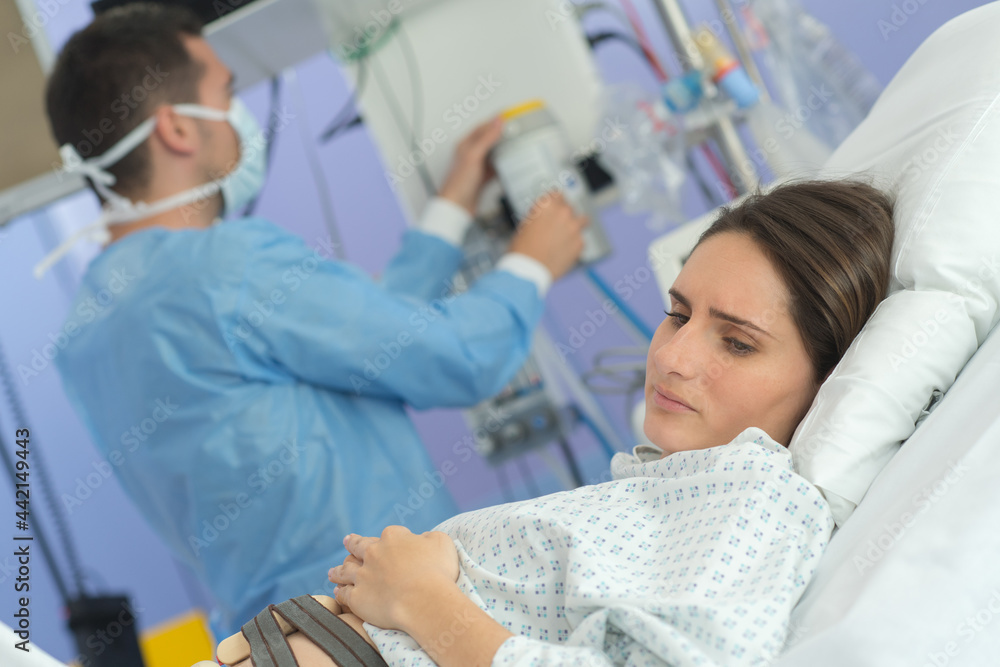 Worried, pregnant lady in hosiptal wearing monitor Worried, pregnant lady in hosiptal wearing monitor