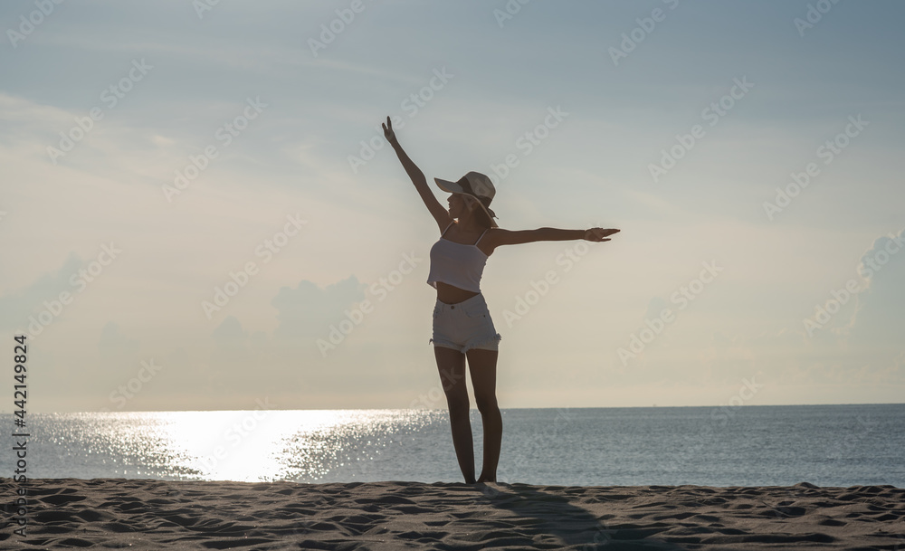 a young woman jumping on the beach. a young woman jumping on the beach.