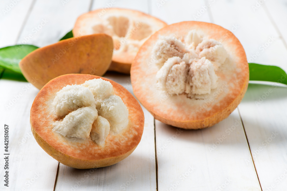 Half Santol on wood background, famous fruit of Lopburi Province. THAILAND Half Santol on wood background, famous fruit of Lopburi Province. THAILAND