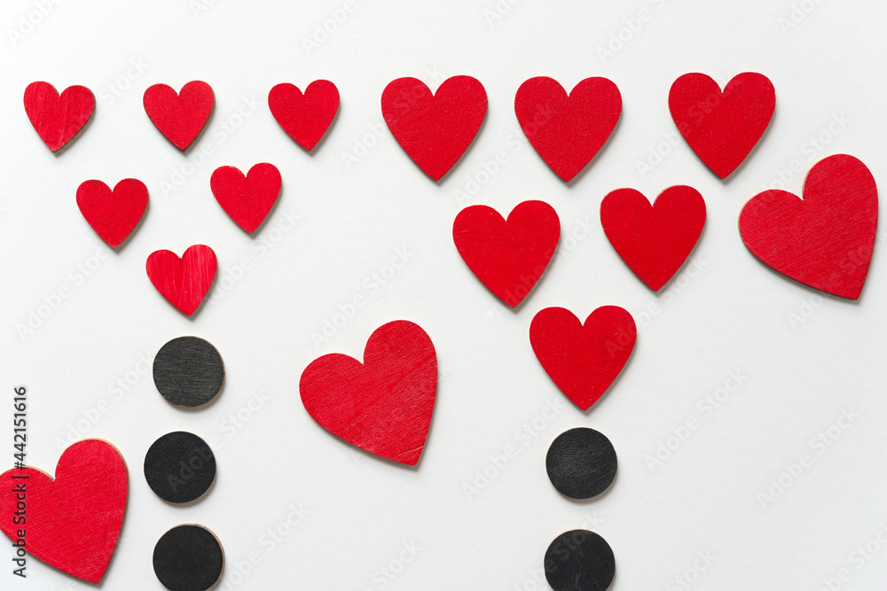 hand painted retro styled wooden hearts and shapes - photographed top-down on a light paper background with ambient light