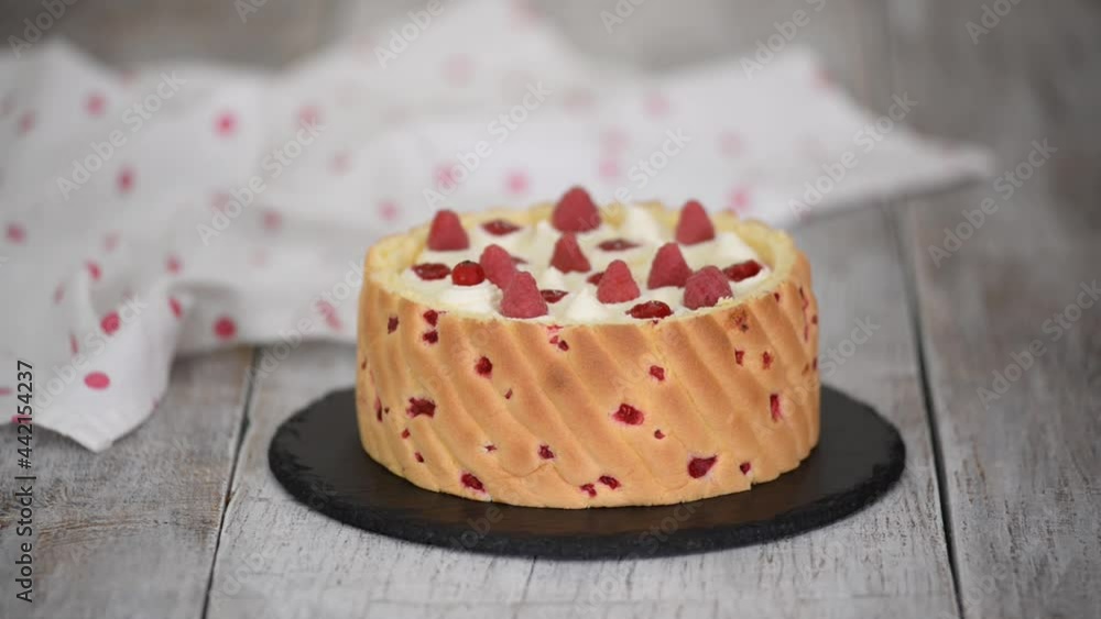 Chef decorating mousse cake with berry. Chef decorating mousse cake with berry.