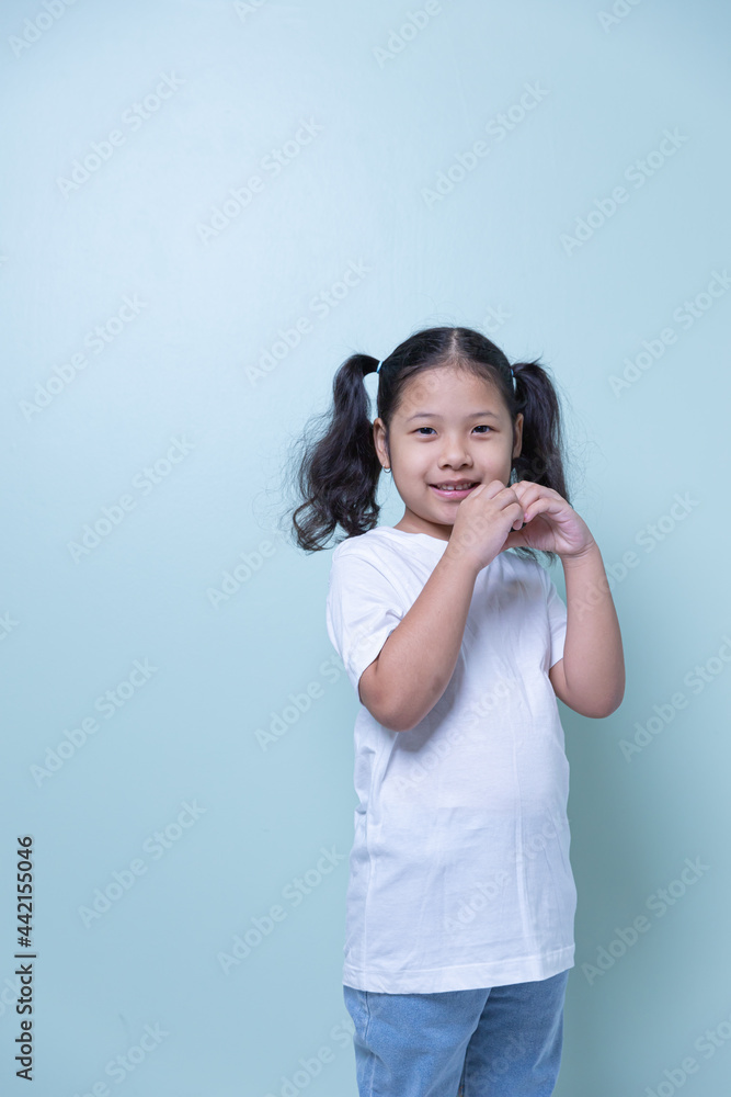 Cute Asian girl happily lovely attractive cheerful cheery very nice looking at the camera, taking a portrait isolated with copy space on a light green background. Cute Asian girl happily lovely attractive cheerful cheery very nice looking at the camera, taking a portrait isolated with copy space on a light green background.